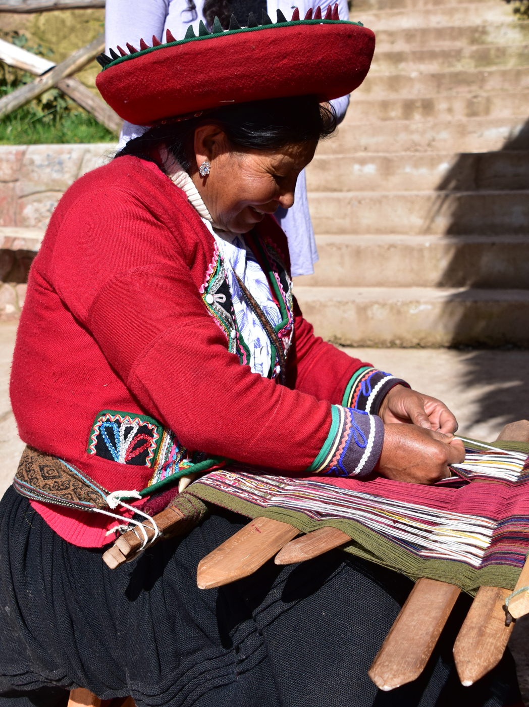 Indigenous Peruvian woman from the Chinchero District in the Andes Mountains demonstrating traditional weaving using locally produced and dyed wool. March 2016. Photograph by Robert R. Oxborrow.