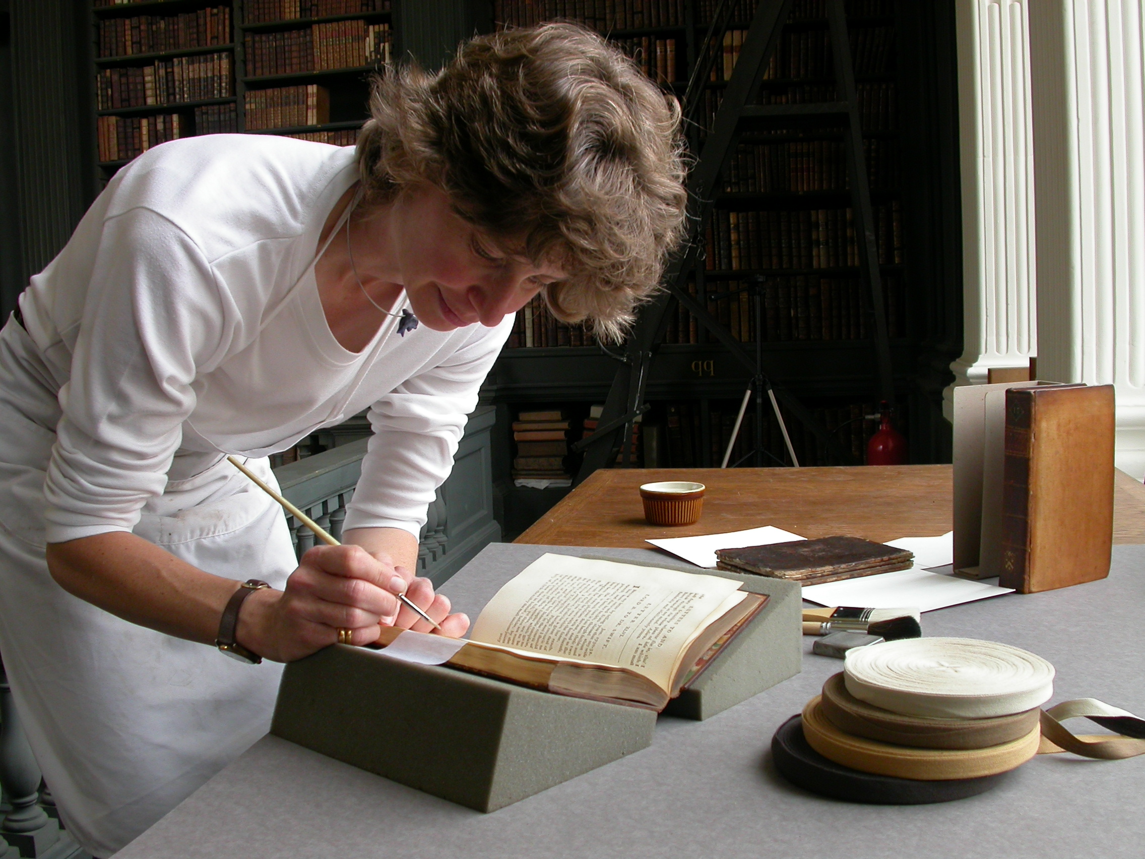 Top image: Sarah Staniforth CBE was awarded the Plowden Medal in 2015 for successfully harnessing science and new technology to make conservation more efficient and practical as well as more environmentally friendly. Image courtesy of the Royal Warrant Holders Association.  Bottom image: Caroline Bendix has restored books in both private and public collections, often in situ, for more than 30 years. Image courtesy of Caroline Bendix.