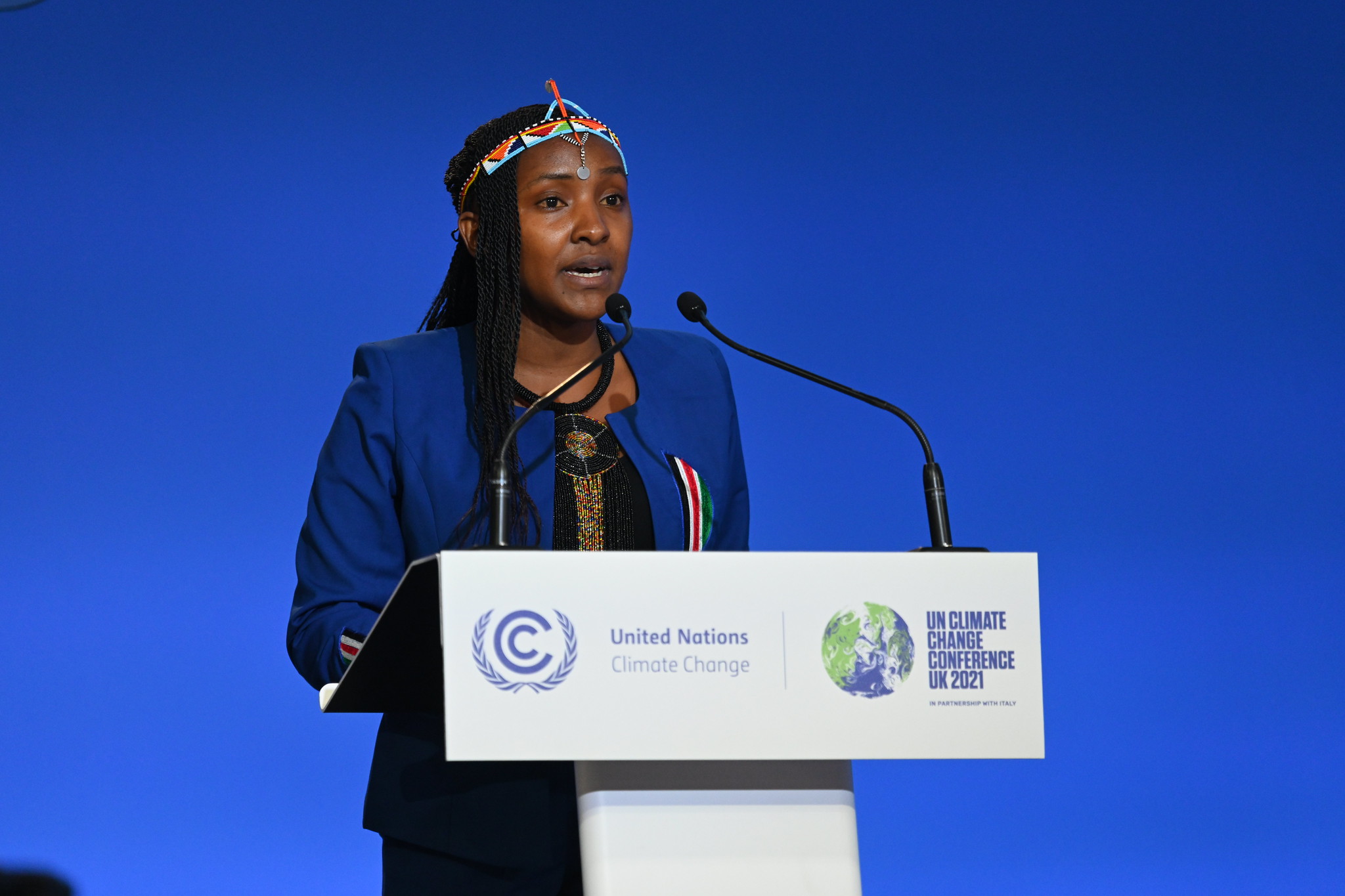 Elizabeth Wathuti speaks at the Opening Ceremony for COP26 at the SEC, Glasgow (Photograph: Karwai Tang/ UK Government) (2021). Image licensed under CC BY-NC-ND 2.0. Original location here.