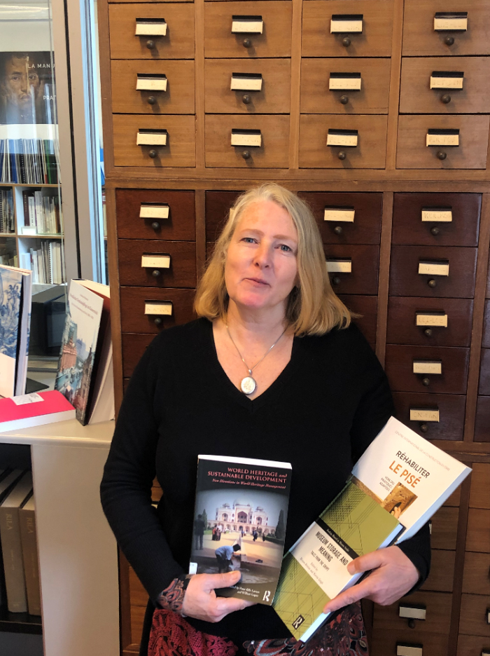 Daniela Sauer holding the three books highlighted in her review. Image courtesy of  ICCROM Library.