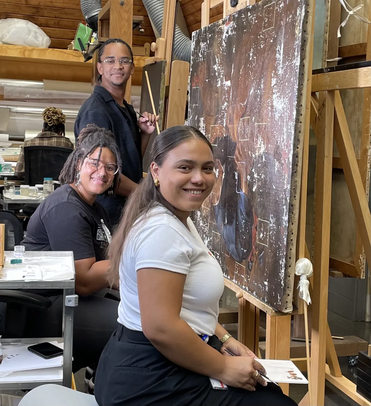Members of the 2023 SIP-C cohort (from front to back: Joyce Vázquez Villanueva, Starr Smith, and Darius Scott) retouching losses on a 17th-century painting of St. Peter by Baburen. Photo by Joyce Hill Stoner. 